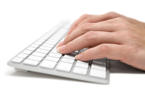 Woman typing on a modern keyboard. White background.
